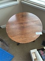 Top view of the wooden tabletop showing scratches and blemishes