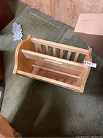 Top and side views of the wooden magazine holder showing the condition and structural details