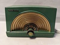 Front view of green RCA Victor tube radio showing tuning dial and knob