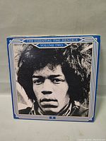 Front cover of The Essential Jimi Hendrix Volume Two vinyl record, black and white portrait cover with blue border.