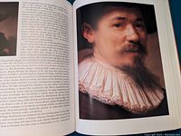 Interior page showing text and a detailed color portrait of a man in 17th century clothing, illustrating Rembrandt's work.