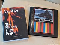 Two art books: 'Visual Art: The Michael Snow Project', softcover; and 'Contemporary Canadian Art', hardcover with colorful art on cover.