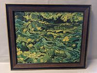 Full view of framed JEH MacDonald print showing the landscape of river and rocks with vintage wooden frame.