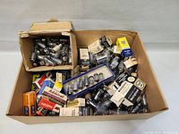 Large box filled with mixed branded and loose vacuum tubes