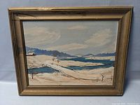 Frontal view of the framed winter landscape painting, showcasing the entire artwork and frame with visible damage on frame corner.