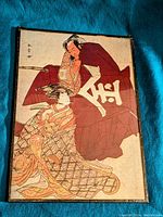 Full view of the ukiyo-e print metal plaque showing Danjuro as Kintoki and a female Segawa family member in traditional attire.