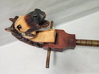 Close-up detail of the carved and painted horse head, showing craftsmanship and painted features.