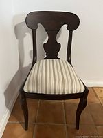 Full frontal photo of the cherry occasional chair showing wood frame and upholstery.