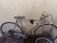 Full side view of Peugeot men's road bicycle with 21-inch frame showing drop handlebars, chain, pedals, and black tires.
