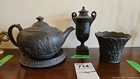 Front view of teapot, urn and vase on surface