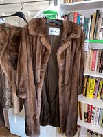 Full frontal view of brown mink coat hanging