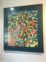 Full view of framed Asian art print of apple orchard scene hanging on wall