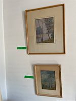 Two framed prints by A.H. Parker mounted vertically, top shows lake shoreline, bottom shows forest scene