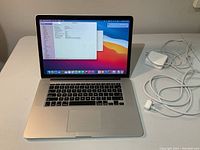 Open MacBook Pro powered on showing desktop and keyboard