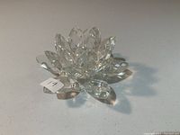 Close view of the multi-petaled clear crystal water lily candleholder showing faceted petals and central candle holder opening.