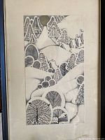 Centered view of framed pen and ink drawing against a neutral wall.