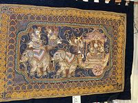 Full view of 19th century Kalaga tapestry featuring elephants, riders, and carriage in rich embroidery with stones and sequins.