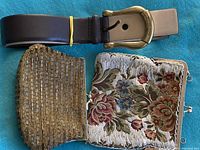 Photo showing dark brown Michael Kors belt with brass-toned buckle and two vintage beaded handbags—one gold-tone beaded and one floral tapestry beaded with chain strap.