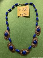 Full view of the antique style choker necklace arranged in oval with a sticky note indicating length 18 inches and price $52.