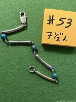 Close-up image of the bracelet laid flat showing the lobster clasp, sterling silver baguette bars, and blue-green turquoise beads alternating along the length.