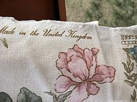 Selvedge close-up showing 'Made in the United Kingdom' printed in gold above a pink flower