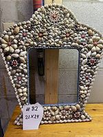 Full view of the folk art shell frame showing shape, size, and overall shell pattern