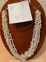 Front view of the necklace displayed on a brown bust with a note indicating #69 and 18" length.