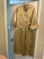 Front view of the vintage Japanese silk jacket showing floral pattern, mandarin collar, and closure buttons.