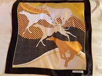 Full view of the vintage St Germain silk scarf laid flat showing the running greyhound dog motif and geometric background.