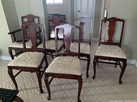 Group of six chairs arranged in two rows showing armchair at left front