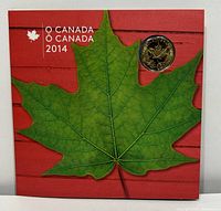 Front of the gift set package showing green maple leaf design on red background with one coin visible.