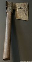 Full view of antique goosewing iron and wood hatchet with visible keyhole cutout in blade and wooden handle.