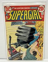 Front cover of DC SuperGirl #1 comic book showing SuperGirl, a man, and a large mechanical object crashing through a wall. Comic is bagged and boarded.