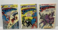 Front view of three Superman comic books, issues #290, #297, and #305, showing colorful covers with classic superhero artwork.