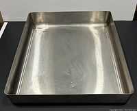 Top-down view of the tray showing scratches and the overall rectangular shape with welded corners and 3-inch deep sides.