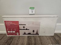 Shelf in sealed packaging showing label and picture of shelf with décor items.