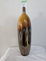 Front view of tall, brown and yellow gradient salt glazed decorative vase