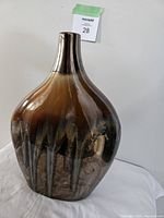 Image of the salt glazed ceramic vase showing bulbous body with dark brown to black color gradient and narrow neck