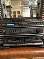 Front view of complete Panasonic stereo music setup showing all three main stacked units and side speakers.