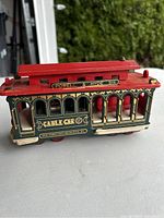 Side view of small model cable car labeled Powell & Hyde Sts, San Francisco Municipal Ry.