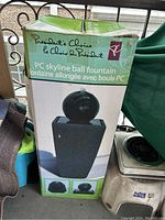 Photo of the PC Skyline Ball Fountain in its original green and white box showing the product image and branding.