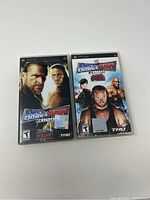 Two PSP game cases showing WWE SmackDown vs Raw 2006 and 2007 editions with visible cover art and THQ branding.