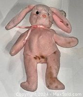 Front facing image showing the pink bunny Beanie Babies plush toy with visible stains on the leg and belly.