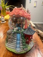 Full view of the Mulan themed snow globe showcasing intricate base details and characters inside the globe