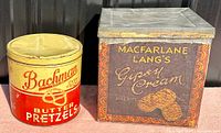 Photo showing Bachman Butter Pretzels round advertising tin and Macfarlane Lang's Gipsy Cream Biscuits square tin side by side