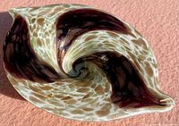 Top-down photo showing the overall oval shape and swirl pattern of dark copper and aventurine colors in the Fratelli Toso murano glass bowl.