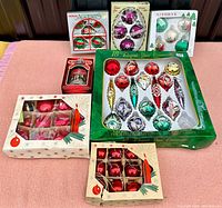 Five boxes of vintage Christmas glass ornaments in original packaging, plus one box containing an Ornamotion carousel decoration.