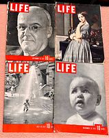 Four LIFE magazines arranged on surface, showing covers with portraits and candid street scenes, dates from late 1930s visible