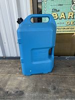 Front view of blue 6 gallon Rubbermaid water tank showing embossed brand and capacity information.