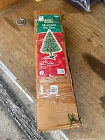 Photo of the sealed box featuring the 6 Foot Rocky Mountain Fir Artificial Christmas Tree label and packaging condition.